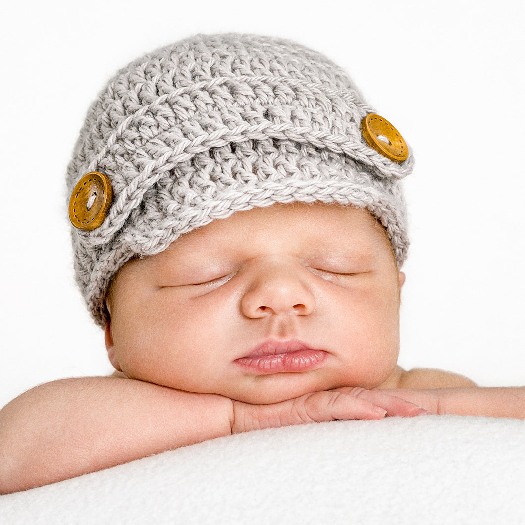 Gray newsboy hand-knitted newborn baby hat with wooden buttons